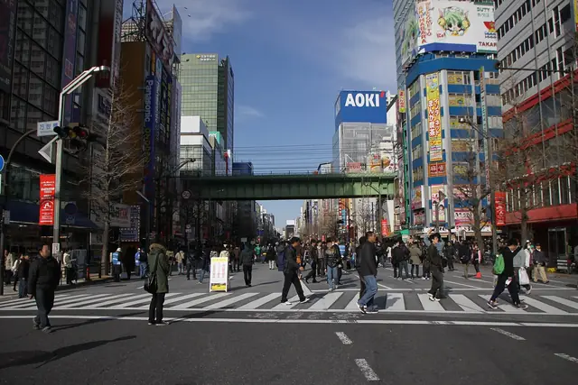 Chuo-dori closed to cars on a Sunday afternoon, with people walking in the middle of the road