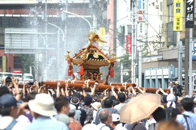 深川八幡祭り、門前仲町の交差点で神輿に水を浴びせる様子
