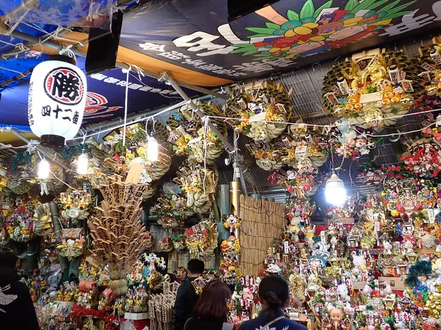 A Tori-no-ichi stall at Hanazono Shrine hung with decorated kumade rakes and paper lanterns