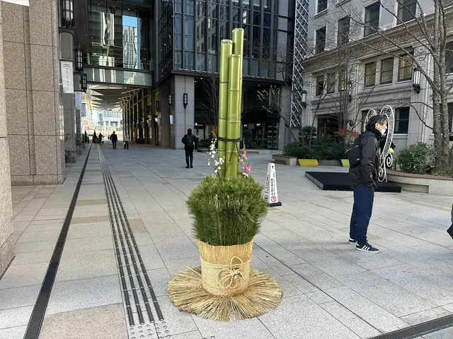 A kadomatsu New Year decoration of pine and bamboo on a pavement in Marunouchi