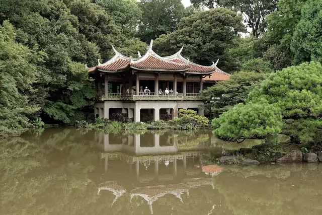 Kyu-goryotei, the Chinese-style pavilion, reflected in a pond of the Japanese garden