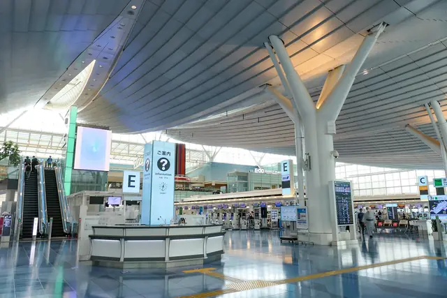 The departure lobby of Haneda Airport Terminal 3, with check-in counters and an information desk