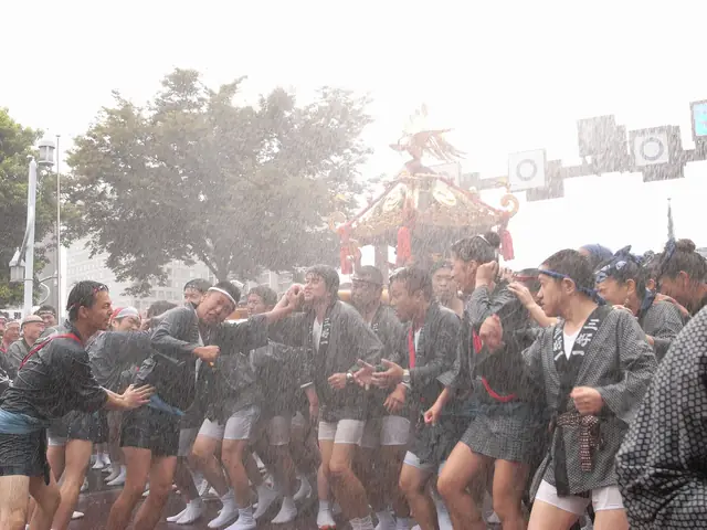 Water is thrown over mikoshi bearers in the street during Fukagawa Hachiman Matsuri