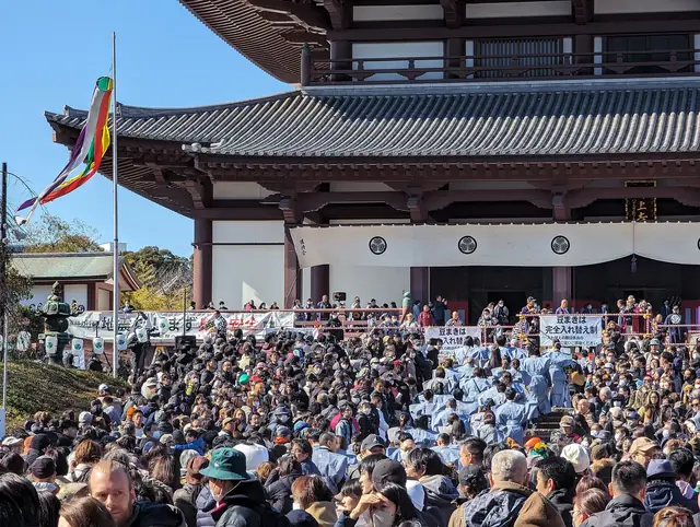 Crowds gather in front of the main hall of Zojoji temple for the Setsubun bean throwing