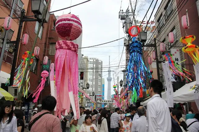 Tanabata streamers hang over Kappabashi Hondori during the Shitamachi Tanabata Festival, with Tokyo Skytree behind