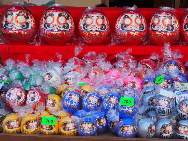Rows of red and colourful daruma dolls for sale at Jindaiji temple in Chofu, Tokyo